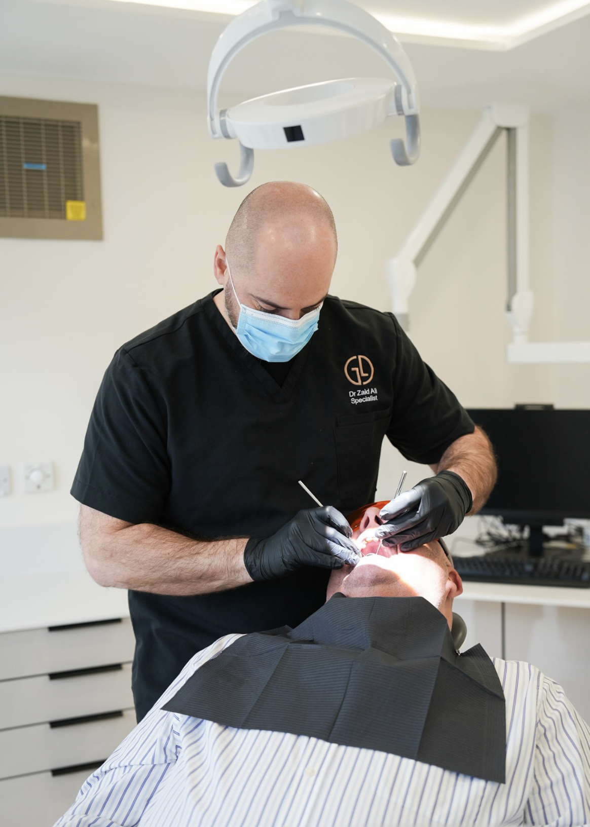 Consultant restorative dentist teaching in a modern clinic